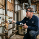 Aging plumbing system inspection showing older water pipes and components that can affect home performance and efficiency.